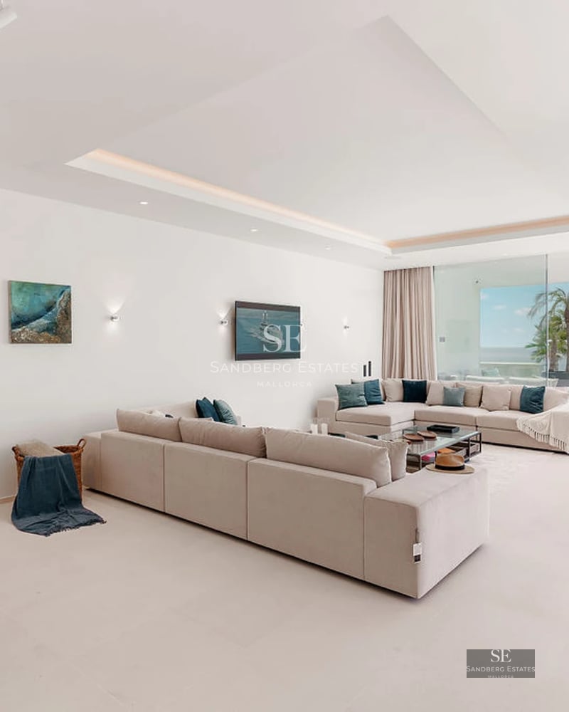 Exterior view of modern villa with pool, landscaped garden, and minimalist architecture. Large windows reflect natural light.