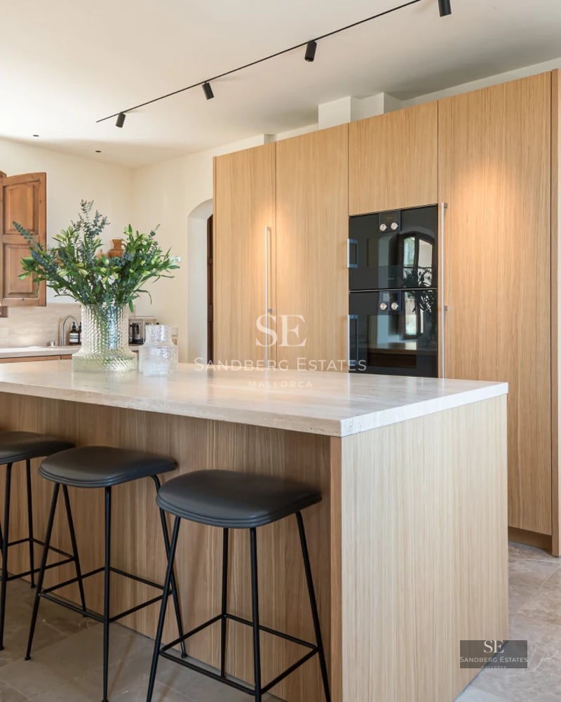 Exterior view of a modern villa featuring an infinity pool, garden, and spacious terraces. Minimalist architecture with large windows.