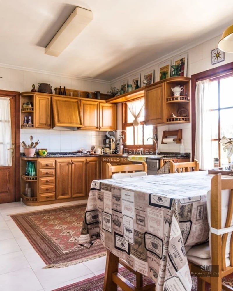 Spacious living room with panoramic windows, modern fireplace, and access to a view terrace. Bright and stylish interior design.