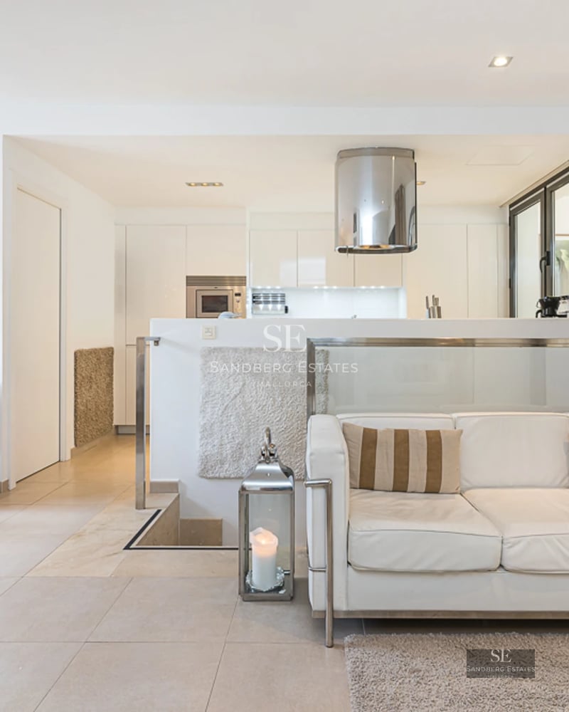 Expansive pool terrace surrounded by gardens. Modern architecture with large windows and luxury finishes.