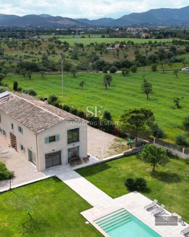 Exterior view of modern villa with infinity pool, expansive terraces, and lush garden. Minimalist architecture and high-quality finishes.