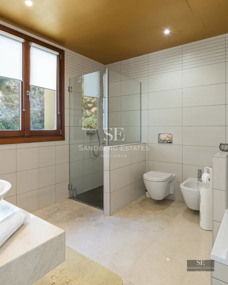 Spacious balcony with sea view. Light wood floors and modern furniture. Glass railing for unobstructed panoramic view.