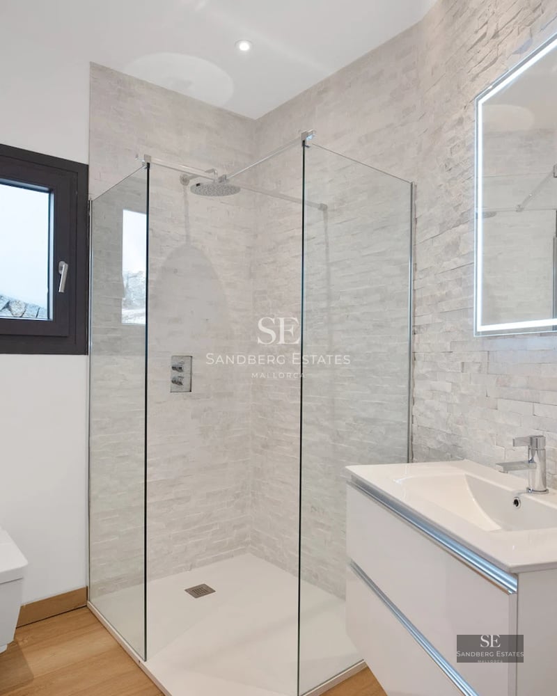 View of infinity pool with loungers, lush garden, and modern villa. Minimalist architecture, elegant design, and high-end finishes.