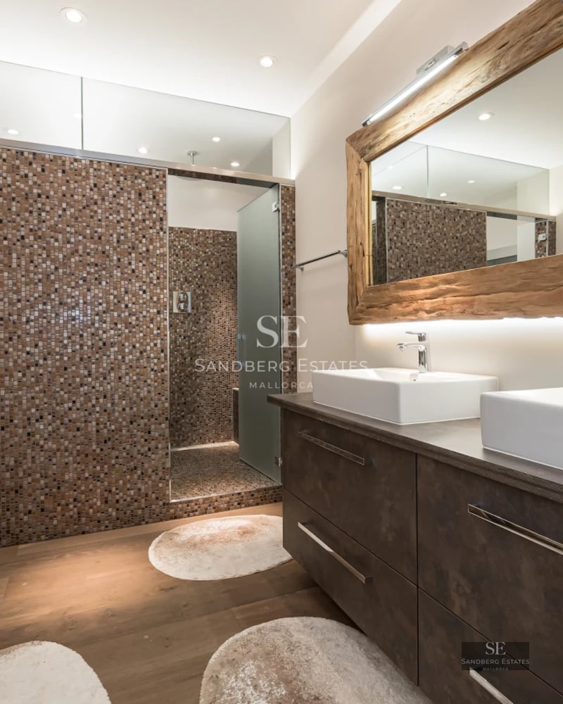 Spacious living room with panoramic windows, modern sofas, stylish rug and stunning ocean views. Bright, minimalist design.