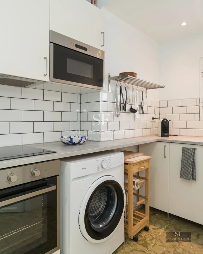 Spacious living room with pool visible through window walls. Modern design, neutral colors, and abundant natural light. Elegant and minimalist furniture.