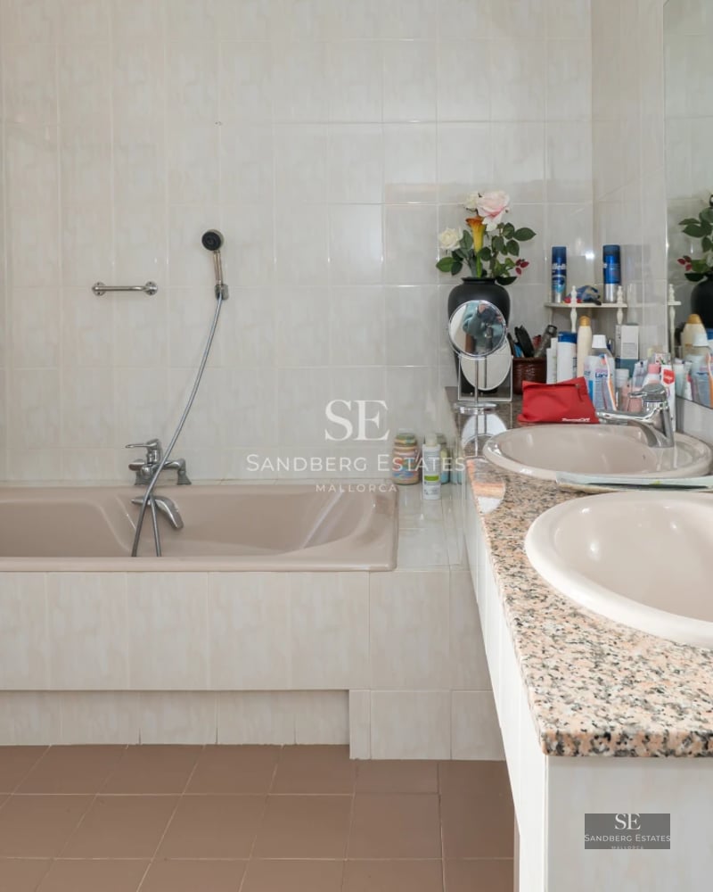 View of modern villa with reflecting pool. Minimalist architecture, large windows and lush landscaping.