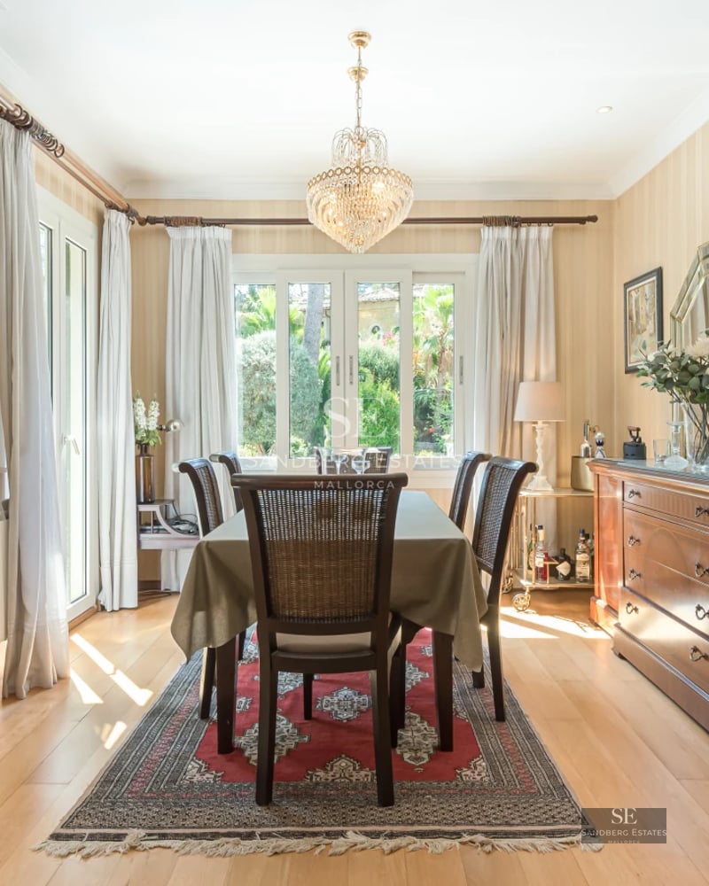 Bright living room with large windows, pool, modern fireplace and designer furniture. Large sofa and minimalist decoration.