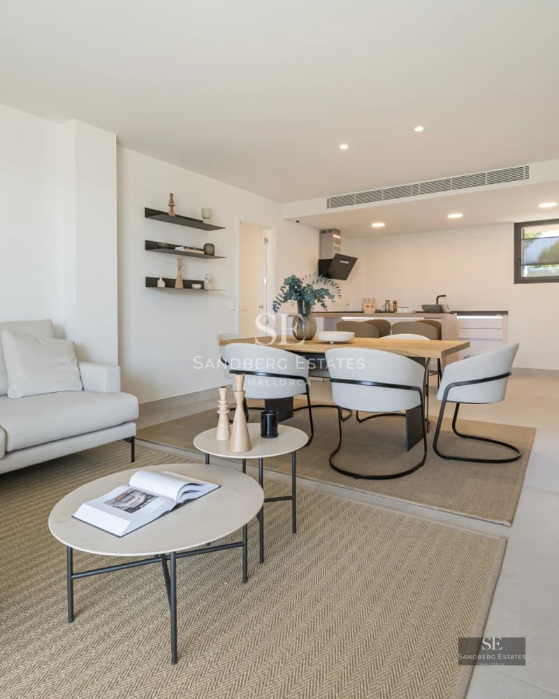 Bright living room with large windows, light wood floors and modern furniture. Panoramic views and minimalist decoration.