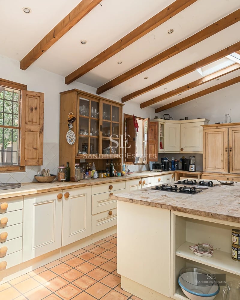 Exterior view of a modern villa featuring a reflective pool, large windows, and lush landscaping.