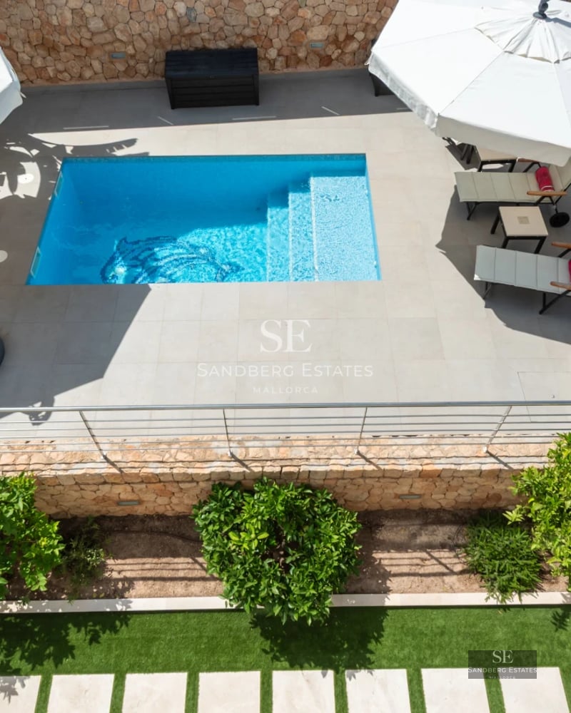 Modern interior with balcony and panoramic sea views. Elegant design, high-end furnishings, and abundant natural light.