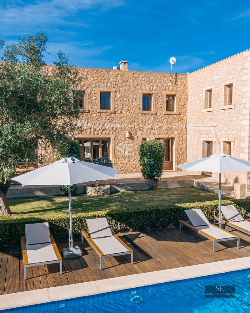 Spacious living room with balcony and panoramic sea view. Modern design, light wood floors, and designer furniture. Natural lighting.