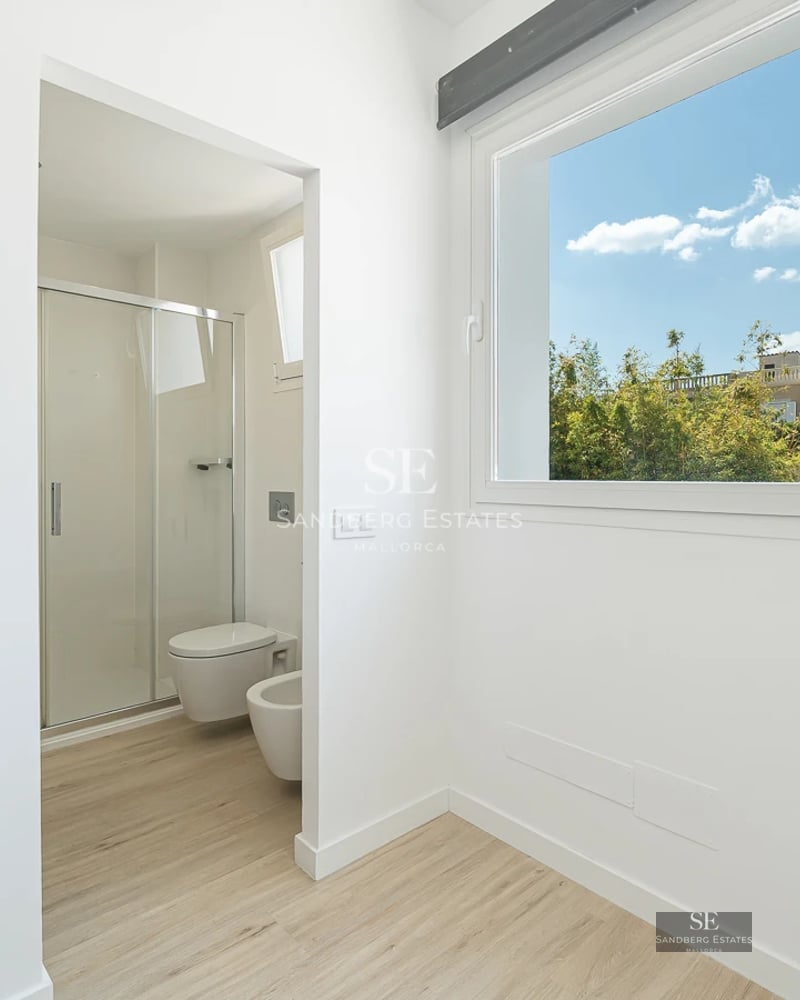 Exterior view of a modern villa with a pool, lush garden, and minimalist architecture. Large windows and high-quality finishes.