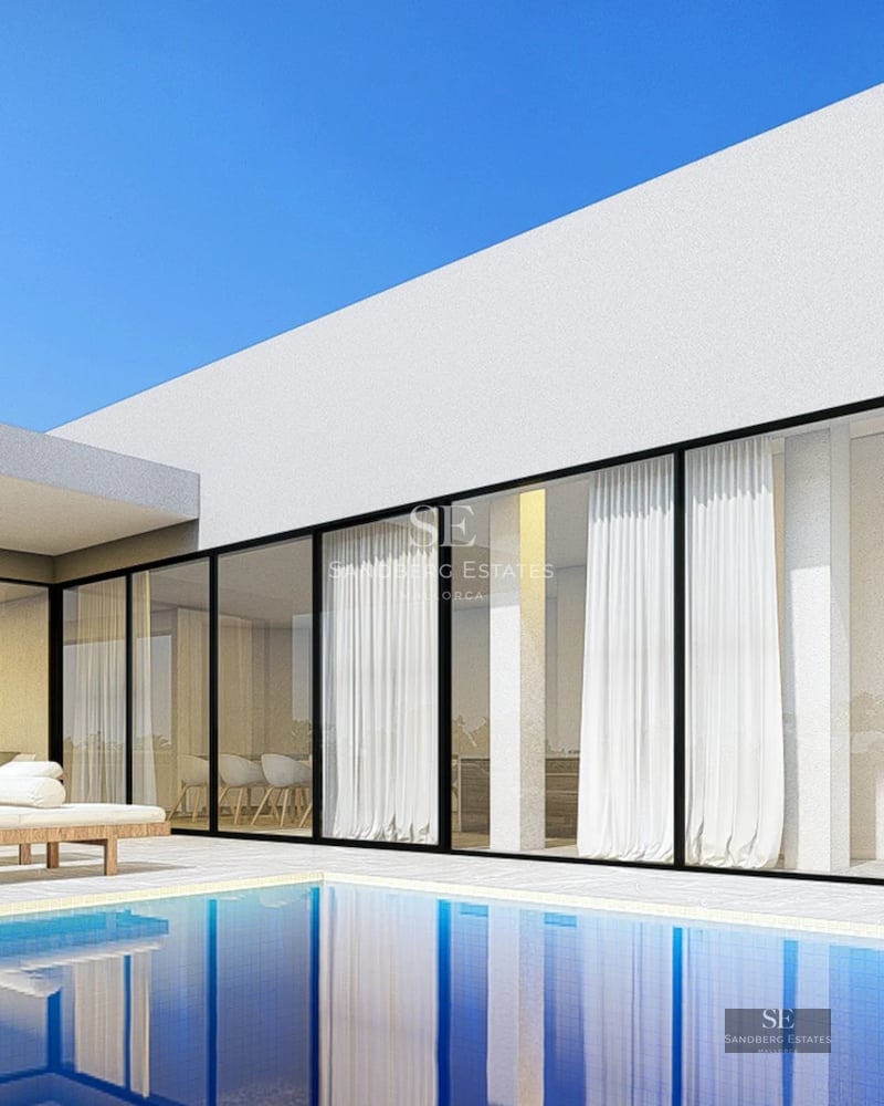 View of an infinity pool with glass edge, surrounded by a modern terrace and lush greenery. Minimalist and elegant architecture.