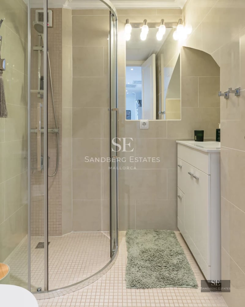 Wide terrace with infinity pool, sea view. Glass railing, sun loungers, and modern minimalist architecture.