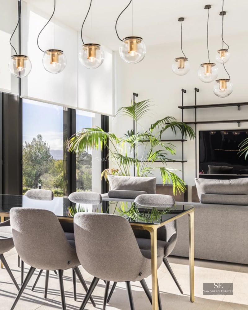 Panoramic view of modern villa with reflecting pool, large windows, and lush landscaping. Minimalist and elegant design.