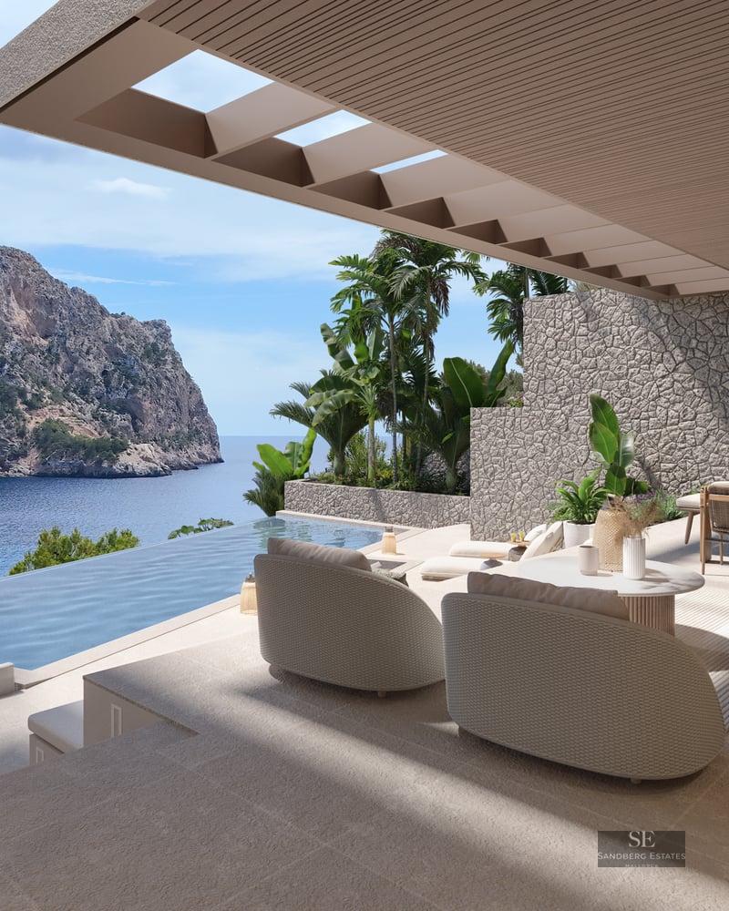 Shaded terrace with designer lounge seating and an infinity pool overlooking coastal cliffs and the blue ocean.