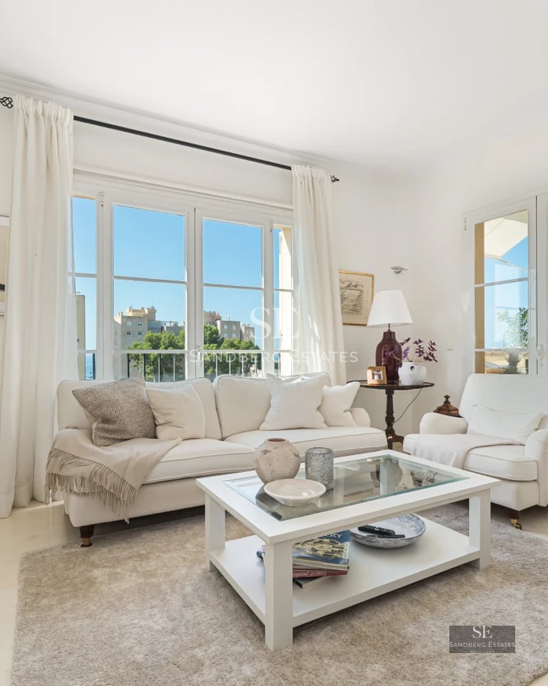 Exterior view of a luxury villa with an infinity pool. Modern design, large windows, lush vegetation, and panoramic views.