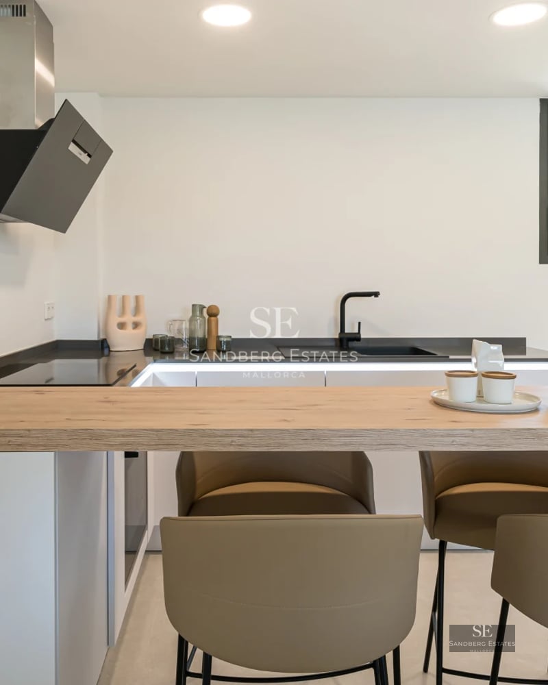 Spacious living room with large windows, sea view, modern furniture, and stylish decor.