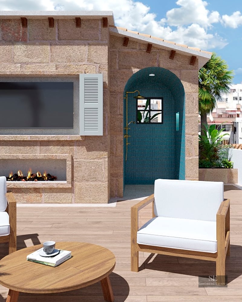 Rooftop terrace with wooden deck, stone wall, outdoor fireplace, TV, turquoise shower, and city view.