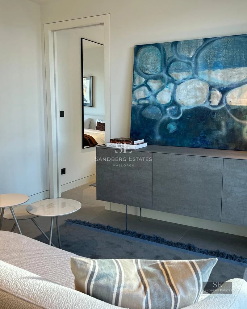 Modern facade with reflecting pool, large windows, minimalist landscaping and ambient lighting.