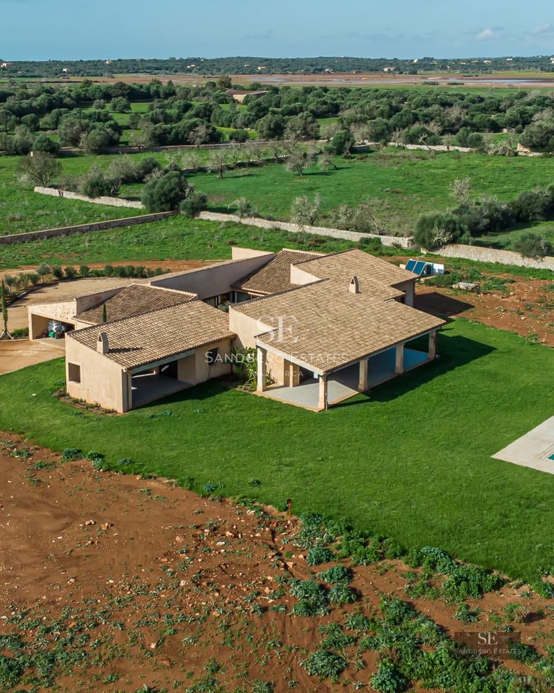Exterior of a modern villa with a pool. Minimalist design, large windows, reflecting pool and lush garden.