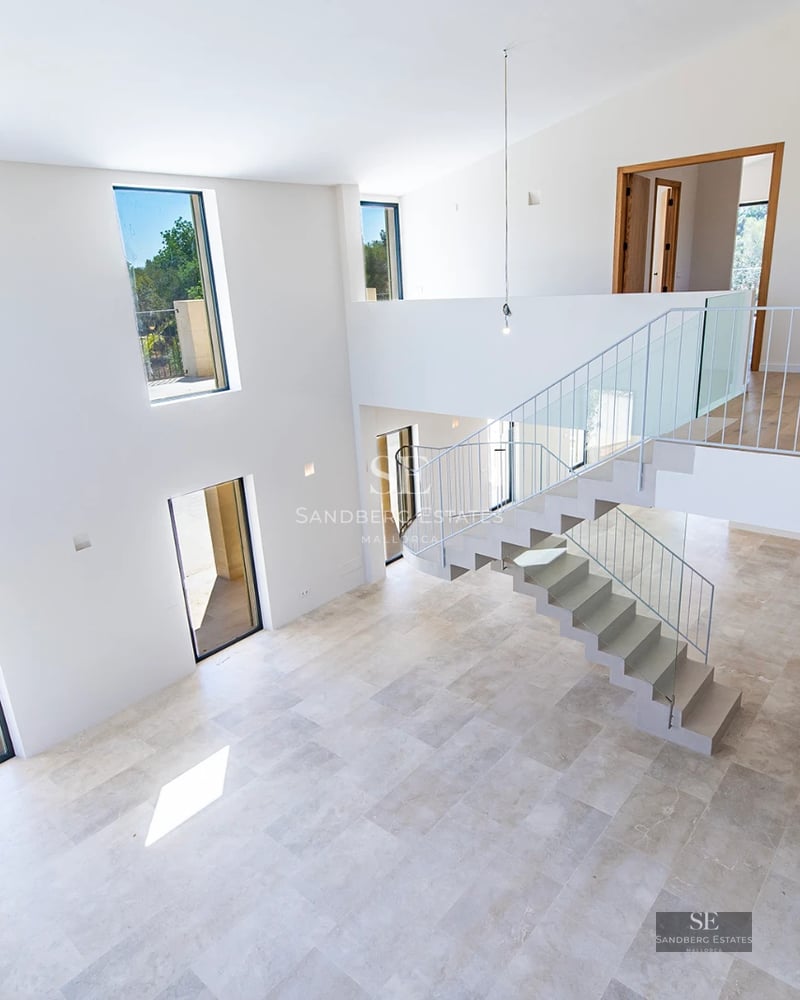 Panoramic view of a modern villa with infinity pool. Minimalist design, large windows, and lush vegetation.