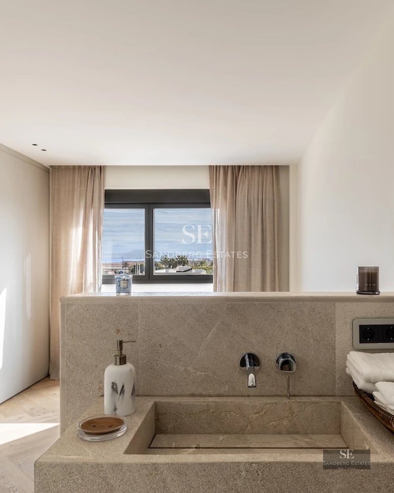 Spacious living room with floor-to-ceiling windows, panoramic sea views and terrace. Modern design, elegant furniture and abundant natural light.