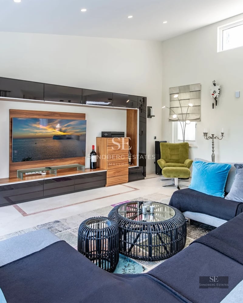 Expansive terrace with infinity pool, lounge chairs, panoramic views, and modern architecture featuring large windows.