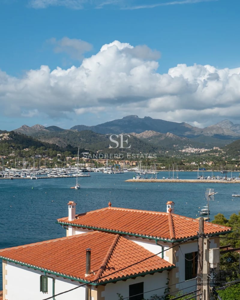 Modern villa exterior with reflecting pool, expansive windows, and manicured landscaping. Soft lighting highlights the architecture.