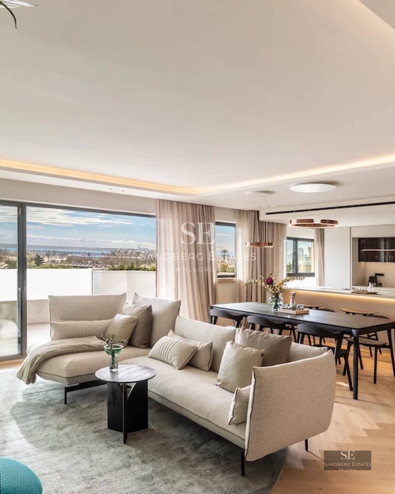 Exterior view of a modern villa with a swimming pool, lush garden, and sleek architectural design. White facade and large window panes.
