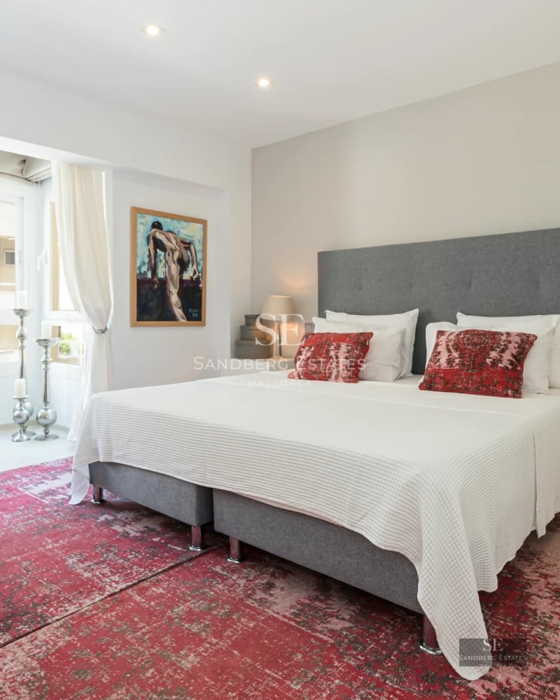 Bright living room with large windows and panoramic sea views. Modern furniture, light wood floors and minimalist decor.