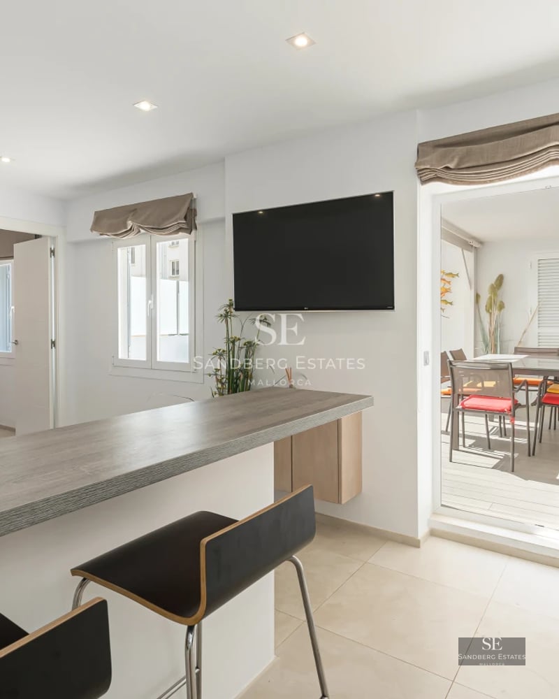 Exterior view of a luxurious property with infinity pool, manicured garden, and modern architecture. Warm sunset lighting.