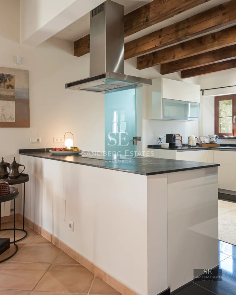 Bright living room with large windows, light wood floors, and panoramic sea views. Minimalist and modern decor.