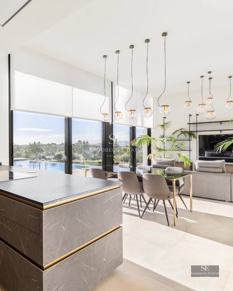 Exterior view of a modern villa with infinity pool, sun loungers, and garden area. Contemporary architecture, ideal for relaxation.