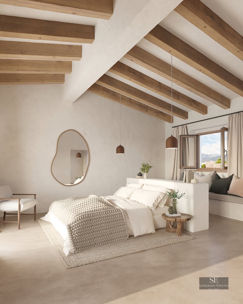 Bright bedroom with high ceilings, exposed wood beams, a large bed, and an organic-shaped wall mirror.