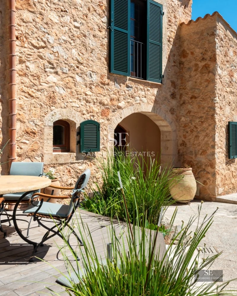 Exterior view of a modern villa with pool, large windows, and minimalist design. Well-manicured garden. Ambient lighting.