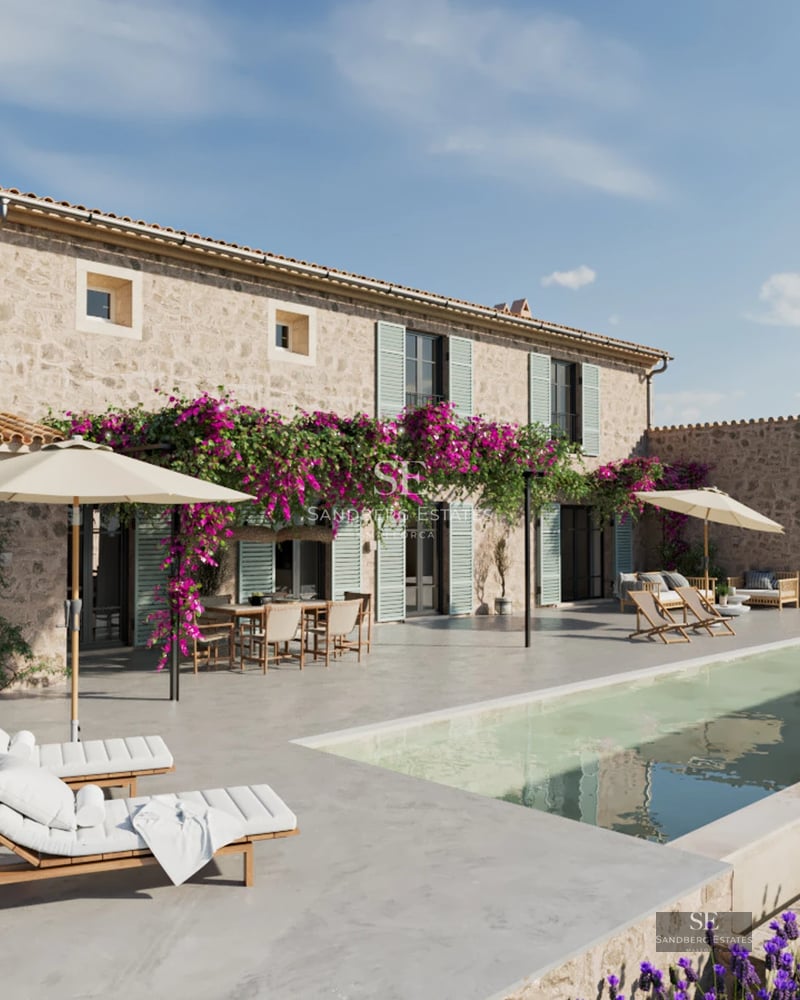 Bright living room with balcony and panoramic views. Gray sofa, textured rug, white walls, and large windows.