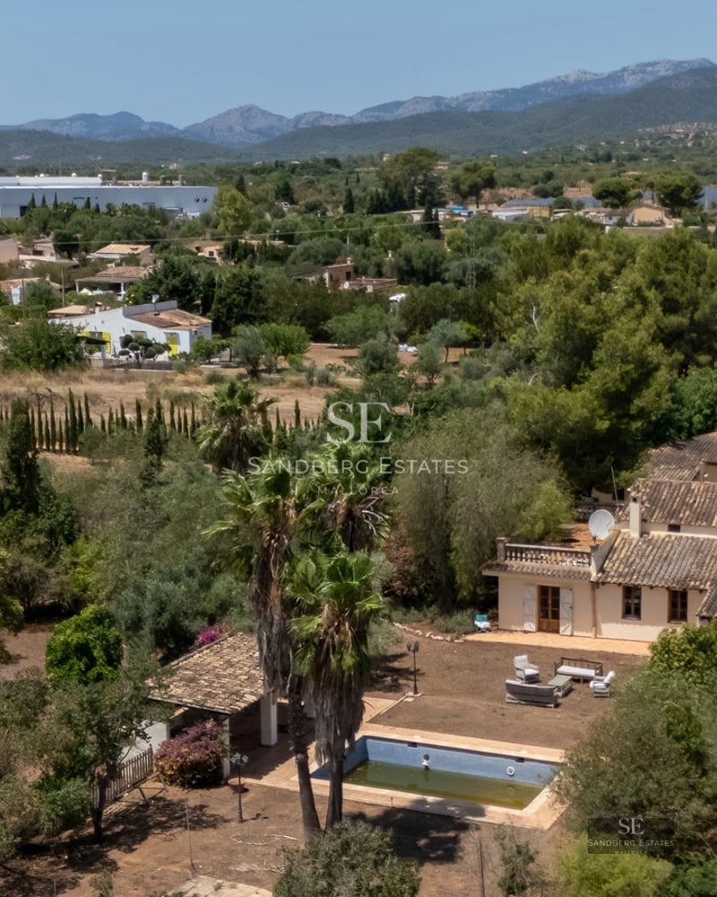 Exterior view of a modern villa with infinity pool, terrace, and expansive windows offering sea views. Minimalist design.