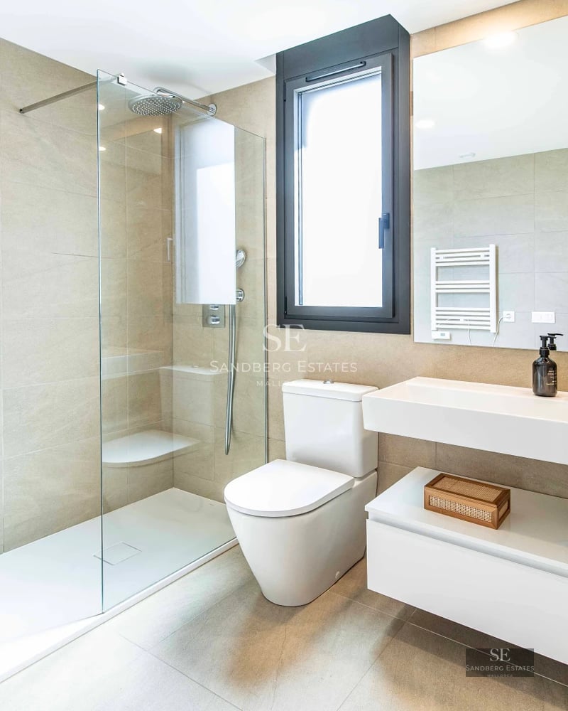 Expansive terrace featuring an infinity pool, modern lounge chairs, and panoramic sea views. Minimalist and elegant design.