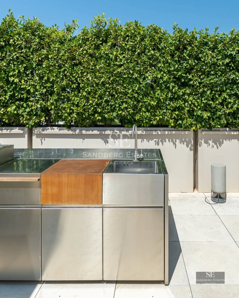 Panoramic view of a modern living room with glazed balcony and sea view. Minimalist design, neutral colors and abundant natural light.