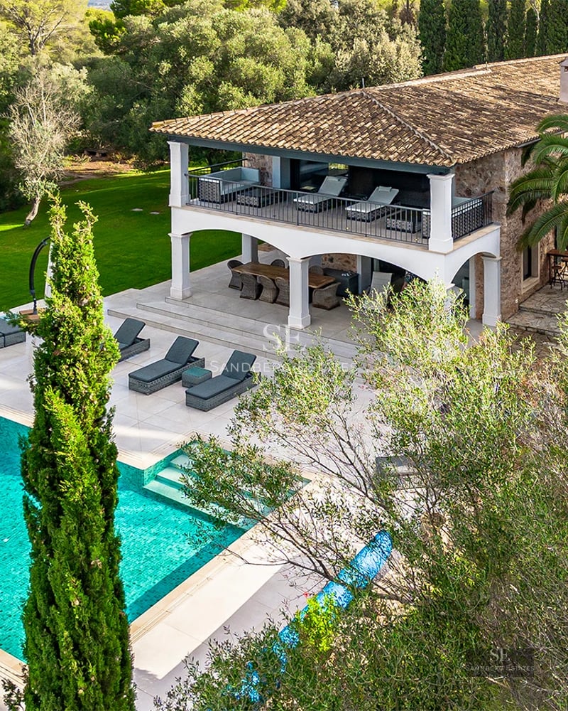 Exterior view of a modern villa with an infinity pool, lush garden, and spacious terraces. Minimalist and elegant architectural design.