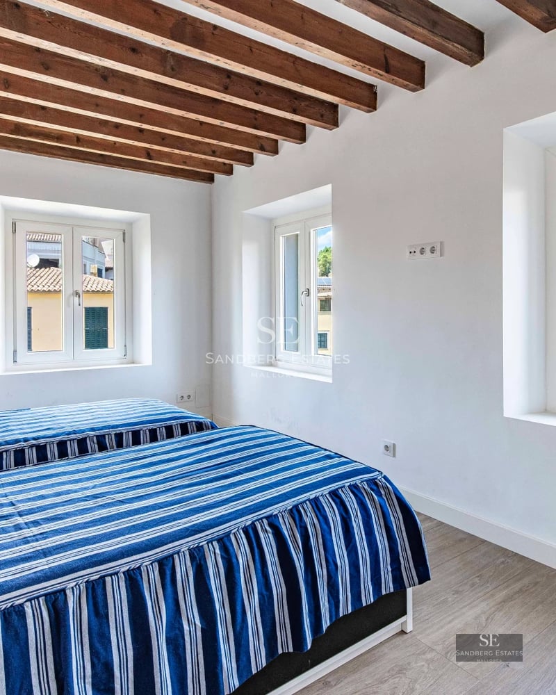 Spacious balcony with panoramic sea view. Modern design, wooden floors, glass railing. Elegant outdoor furniture.