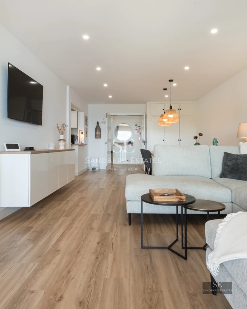 View of modern villa featuring a pool, spacious garden, and minimalist design. Large windows illuminate the interior.