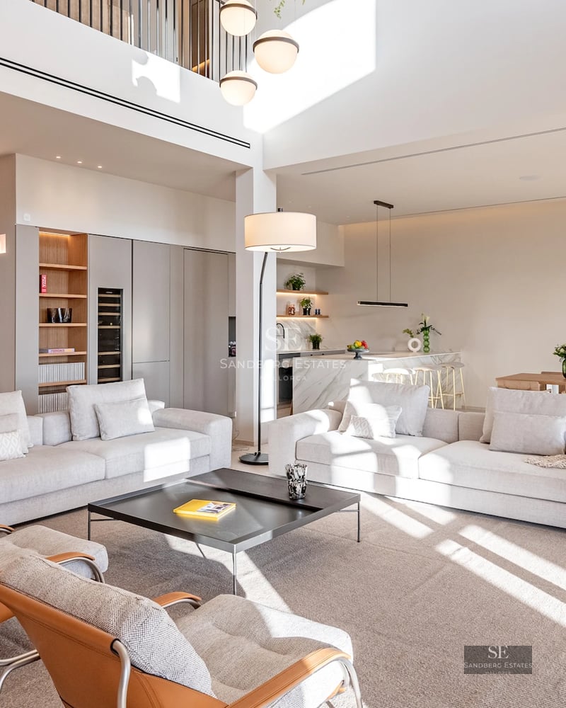 Expansive terrace with infinity pool. Modern design featuring wood flooring and ocean views. Loungers and umbrellas for relaxation.