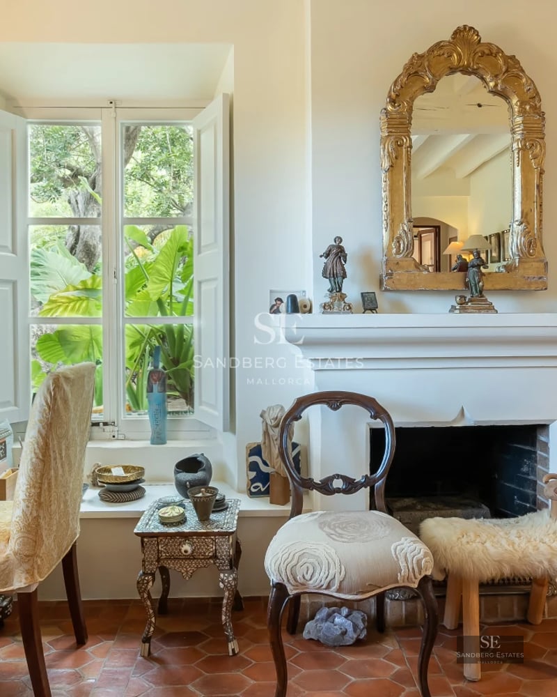 Exterior view of a modern villa featuring a pool, manicured lawn, and large windows reflecting sunlight.