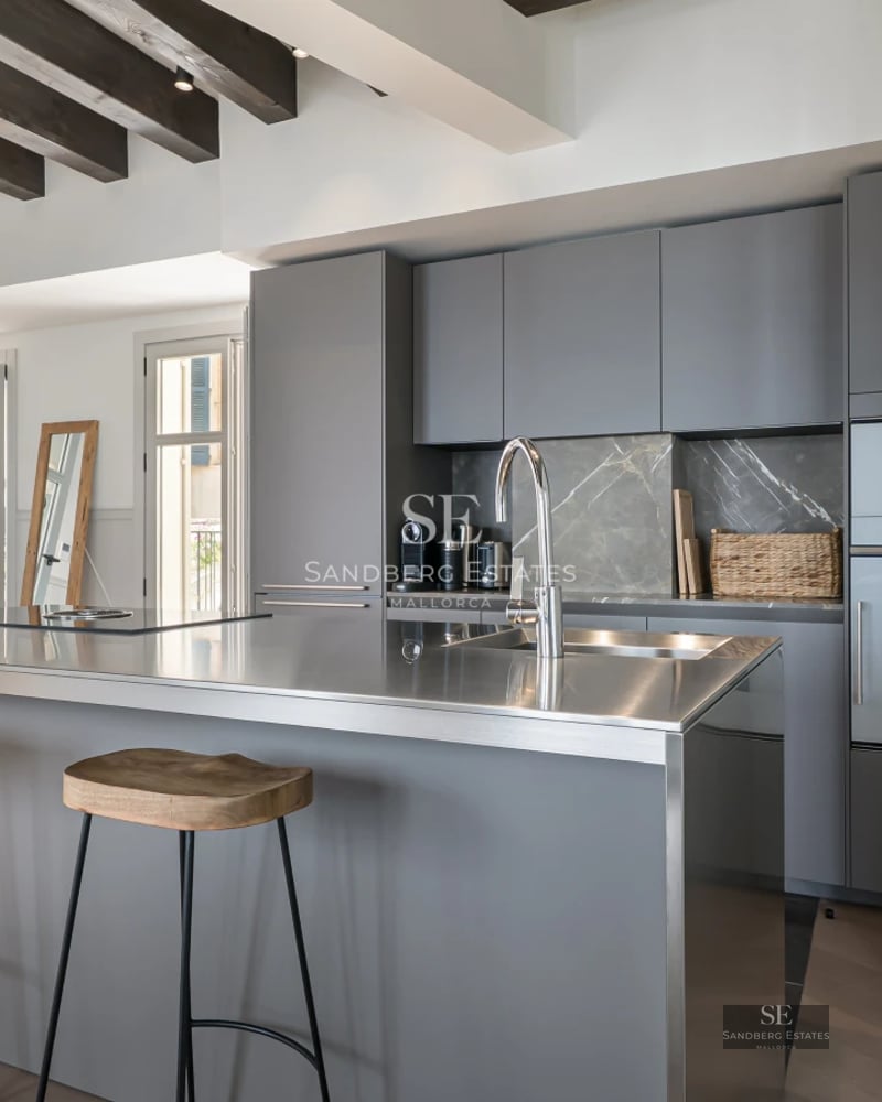 View of a luxurious pool with terrace, loungers, lush greenery, and modern architecture. Natural lighting and relaxing atmosphere.