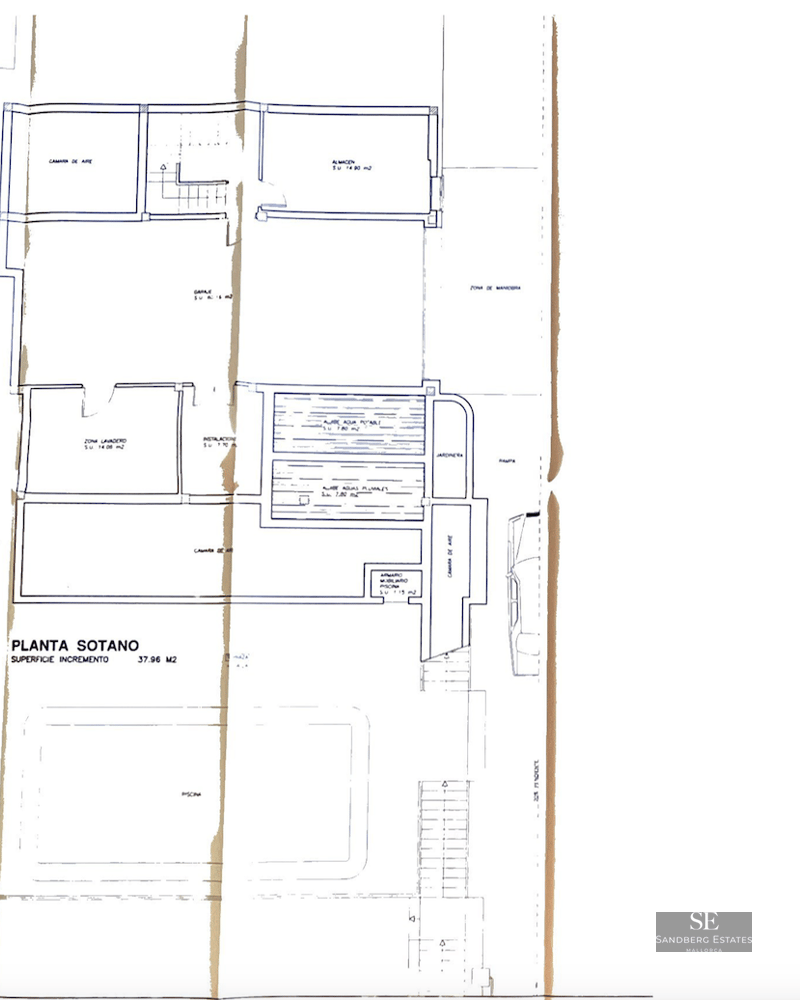 Architectural drawing showing the basement layout, including a garage, storage, and laundry areas.