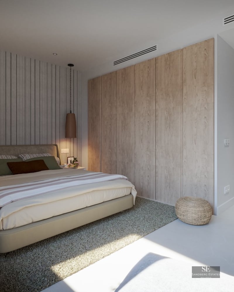 Modern bedroom featuring a large bed, light wood built-in wardrobes, a striped accent wall, and designer pendant lights.
