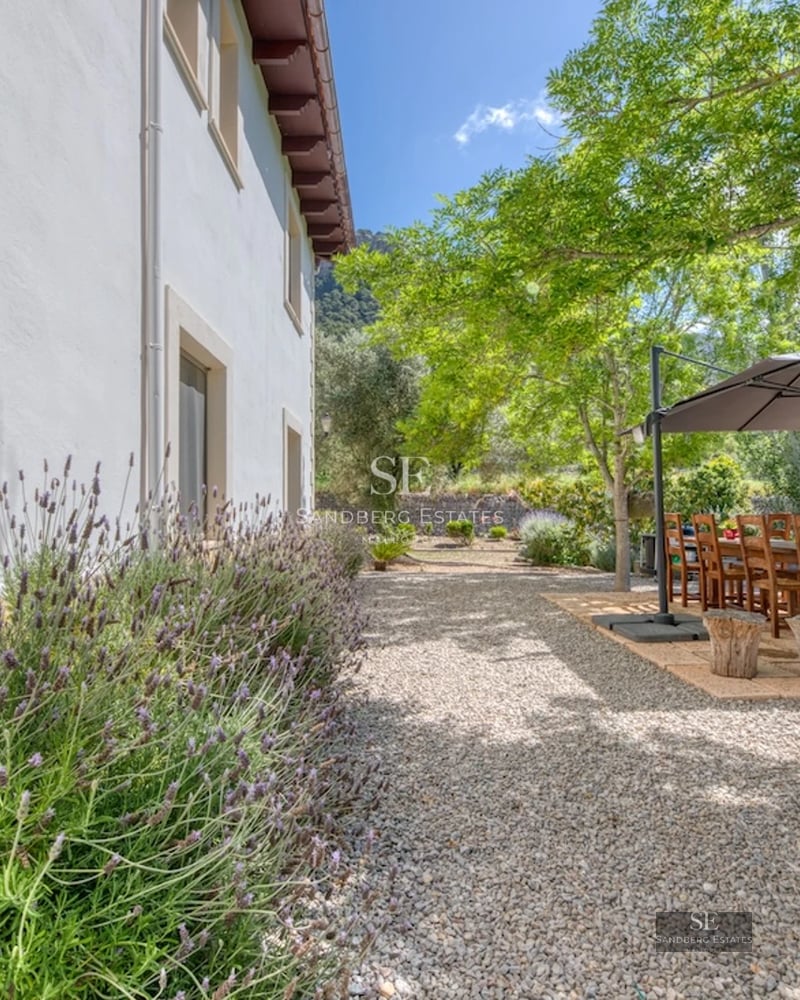 Spacious living room with balcony and sea view. Modern design with natural light, wood flooring, and stylish furniture.