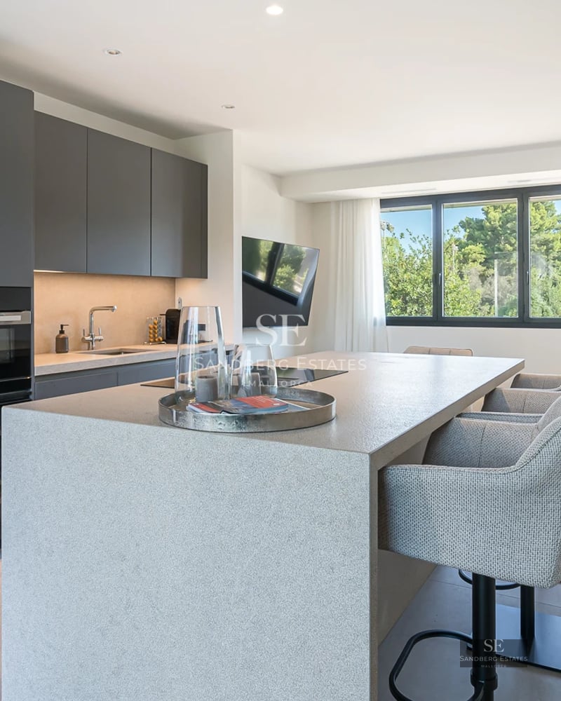 Exterior view of a modern villa featuring an infinity pool, expansive terraces, lush garden, and minimalist architecture. Luxury and design.